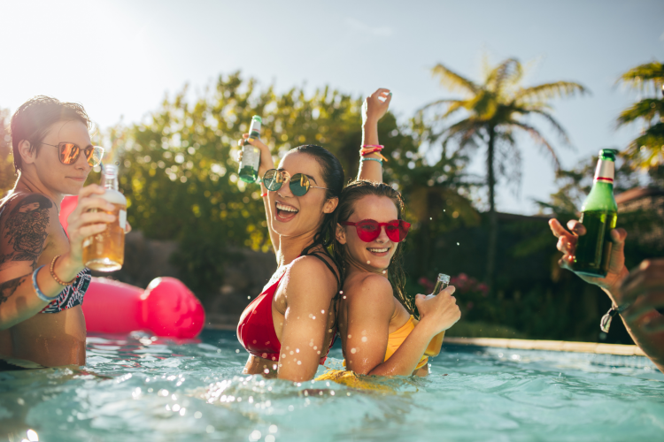 friends enjoying drinks at a pool party