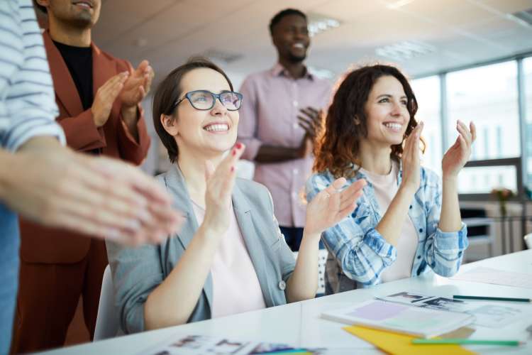 colleagues clapping for each others' achievements