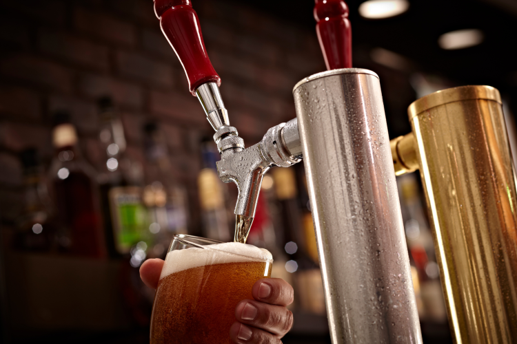 bartender pouring a pint of beer