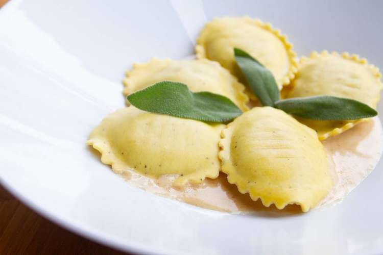 plated ravioli topped with sage leaves