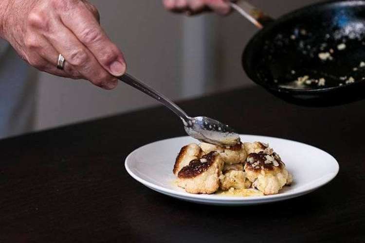 chef plating roasted cauliflower