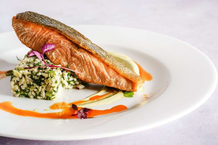 seared salmon steak over herbed couscous