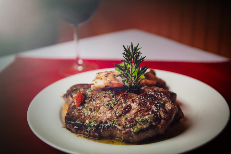 ribeye steak plated with wine