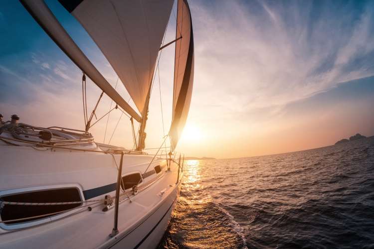 sail boat on the water during sunset