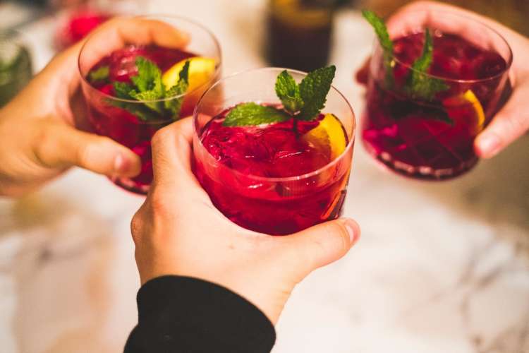 friends holding glasses of sangria