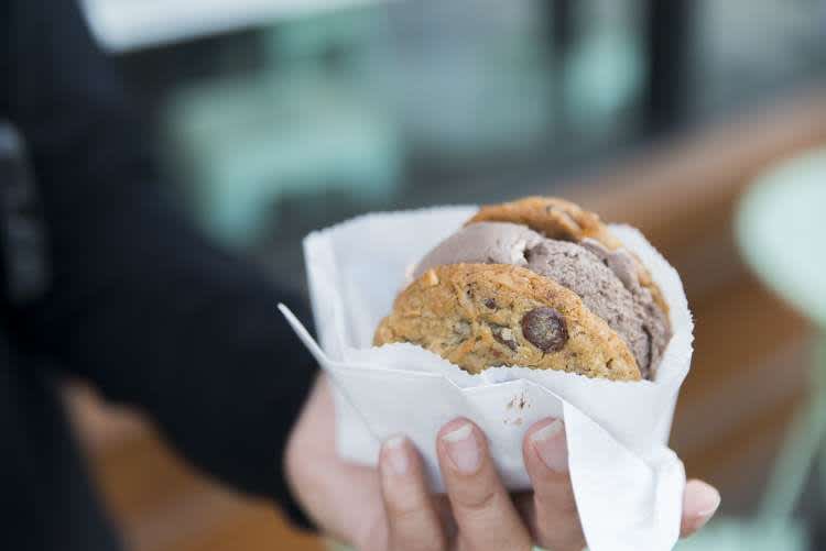 woman holding a cookie for a girls night dessert party