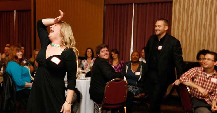 People acting and watching during a murder mystery dinner