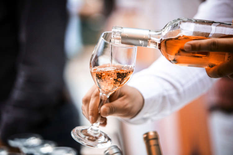 server pouring white zinfandel