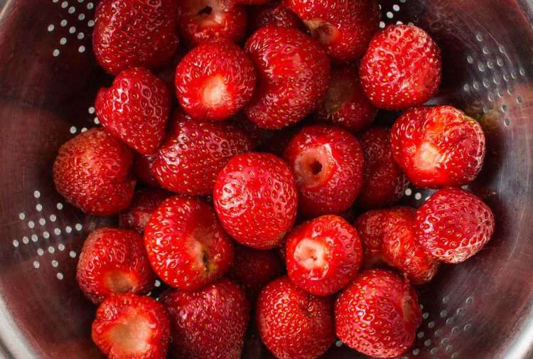 strawberries in a metal colander 