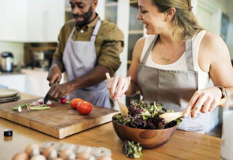 couple practicing healthy cooking together in the kitchen