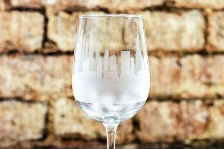 wine glass with etched city skyline along the perimeter