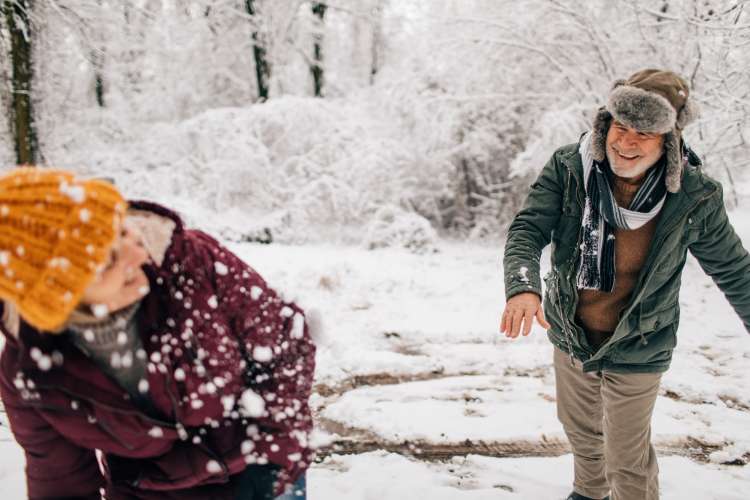 couple having a snowball fight