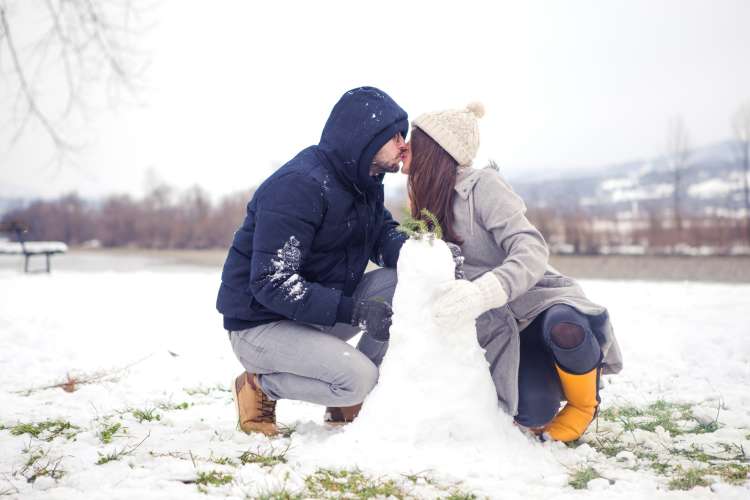 couple building a snowman