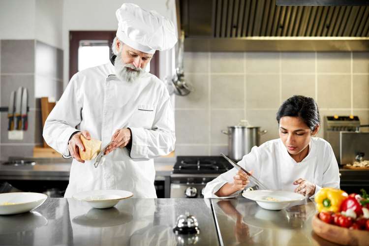 a sous chef instructing a line chef