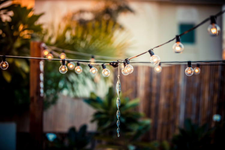 string lights hung up over a backyard