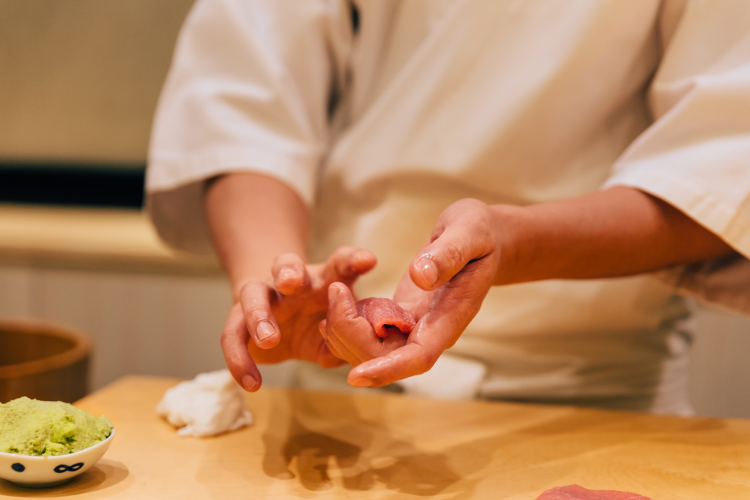 sushi chef preparing fish