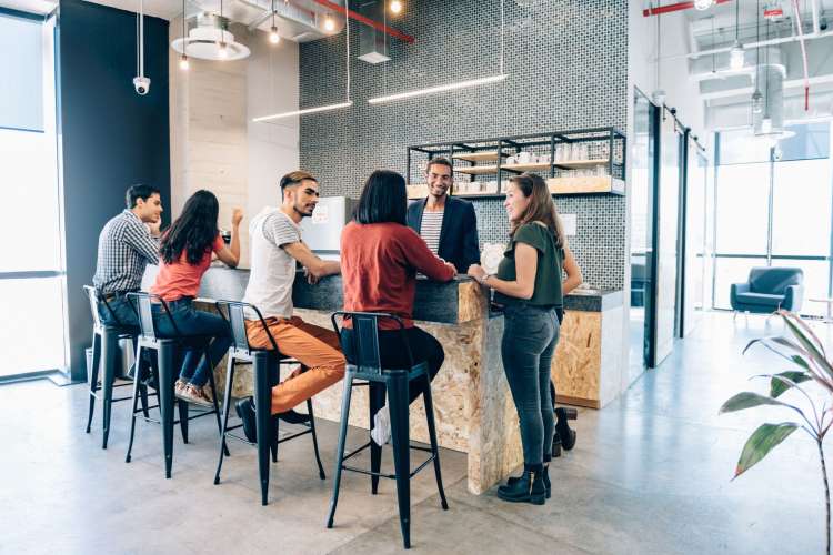 Six people sitting and standing around having conversations