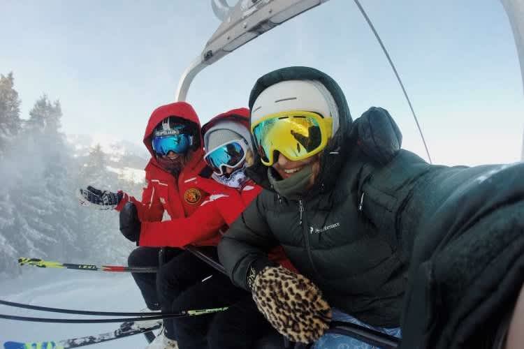 friends on a ski lift to go skiing