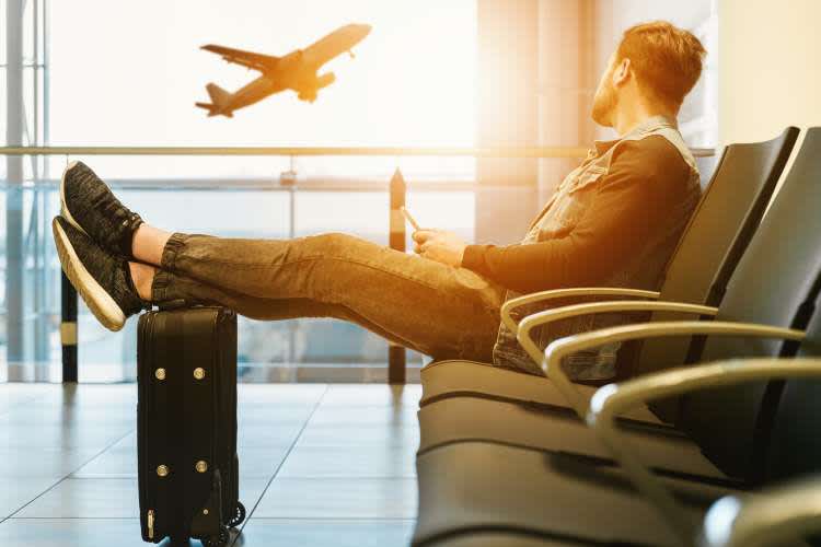 man waiting for his flight in the airport