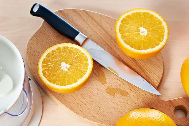 utility knife on a cutting board with orange slices