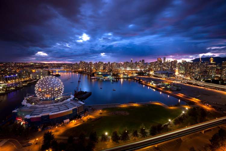 a vibrant sunset over the water in downtown Vancouver