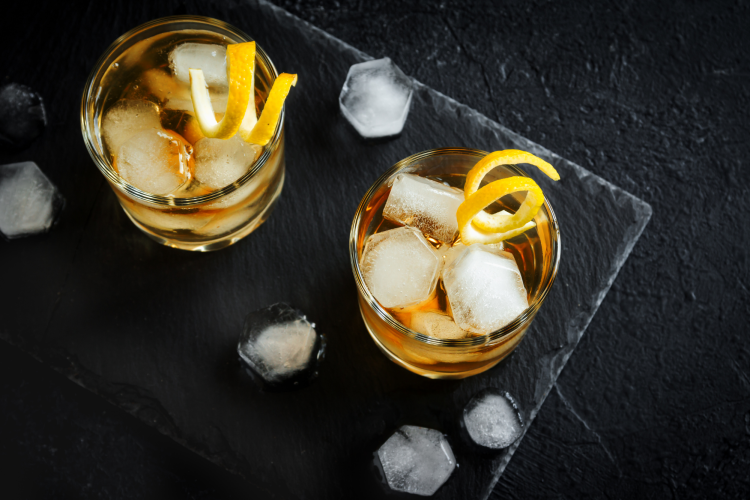 whiskey cocktails on a slate tray