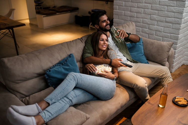 couple relaxing on the ouch watching tv