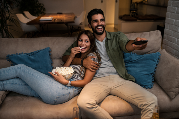 couple watching tv together on the couch