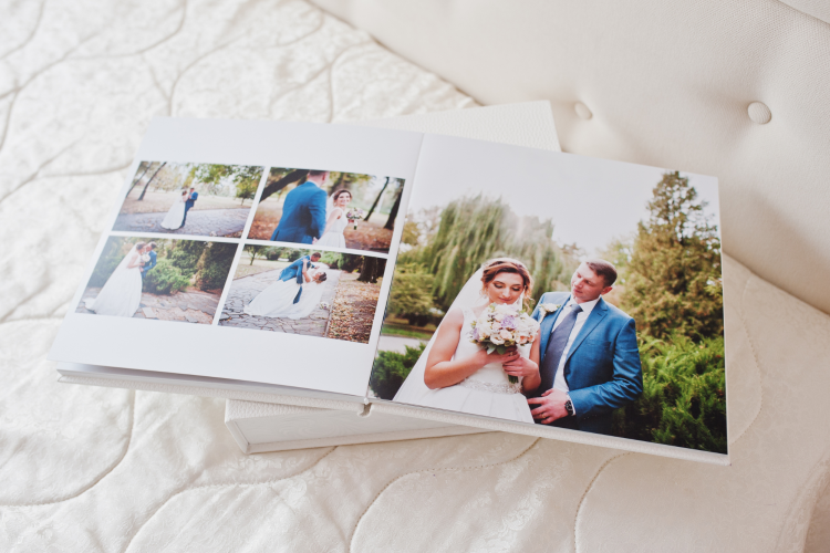 wedding album showing wedding photos lying open on a bed