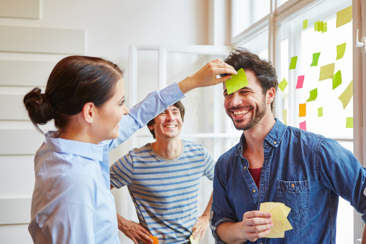 colleagues playing a game with sticky notes