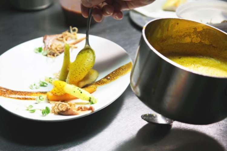 chef plating food at schwa in chicago