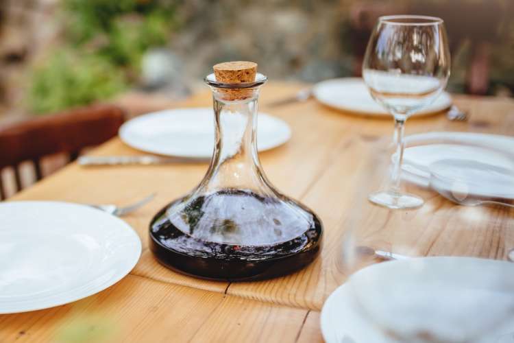 decanter of red wine on outdoor dining table