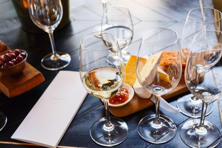 white wine, cheese and notepad during a wine tasting