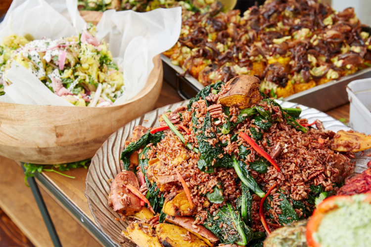 plates of prepared food on a table at a company potluck