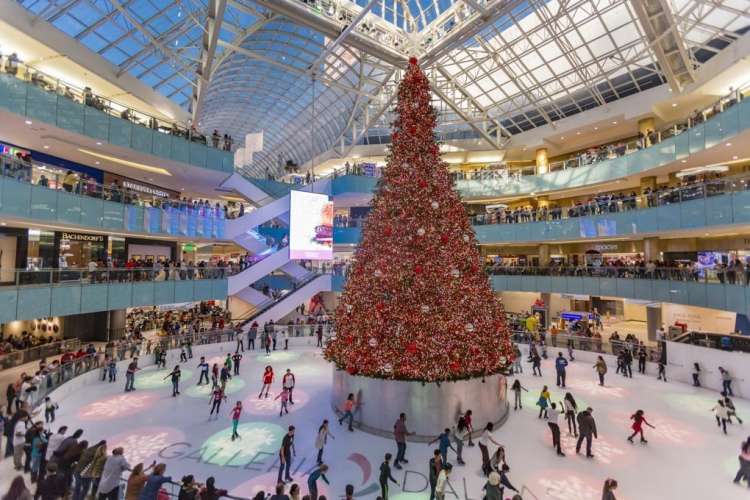 people ice skating indoors at the galleria dallas during the holidays