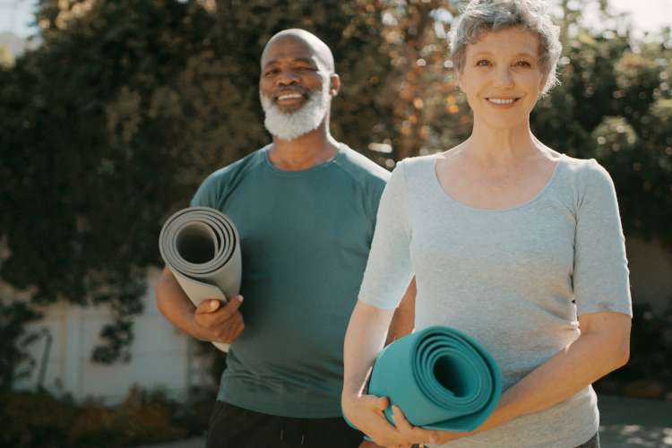 middle aged couple getting ready to do yoga