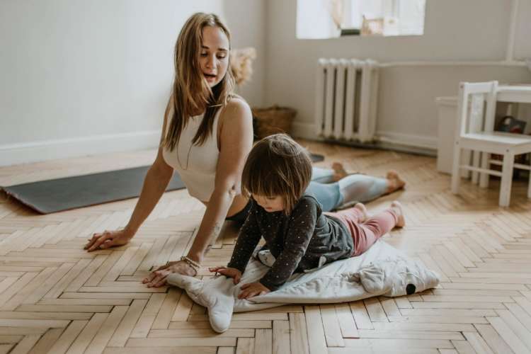 woman doing yoga with young child