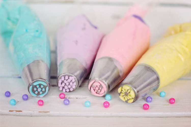 piping bags full of colorful buttercream frosting