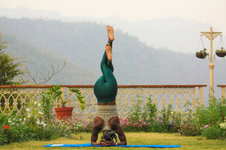 woman doing a headstand during her yoga practice