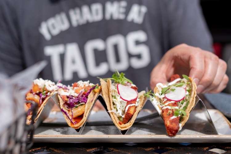 hand reaching for tacos