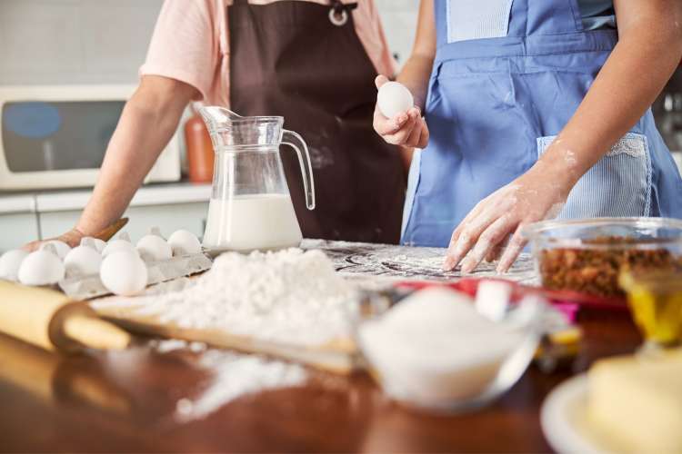 two people baking in the kitchen