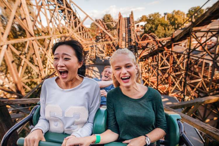 two people screaming on a roller coaster