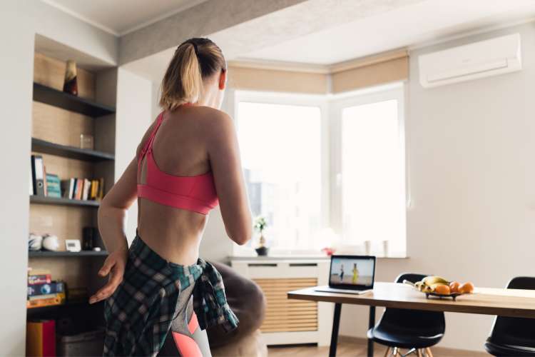 woman dancing at home with computer