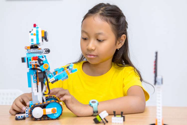 child building robot with LEGO