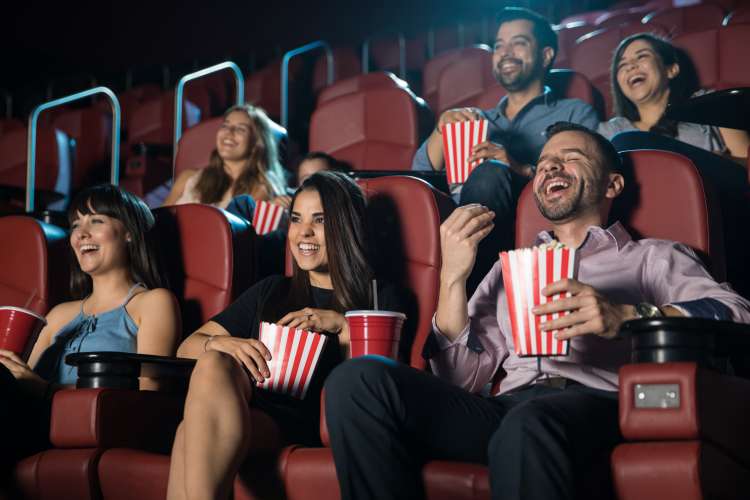 group of friends watching movie in theater