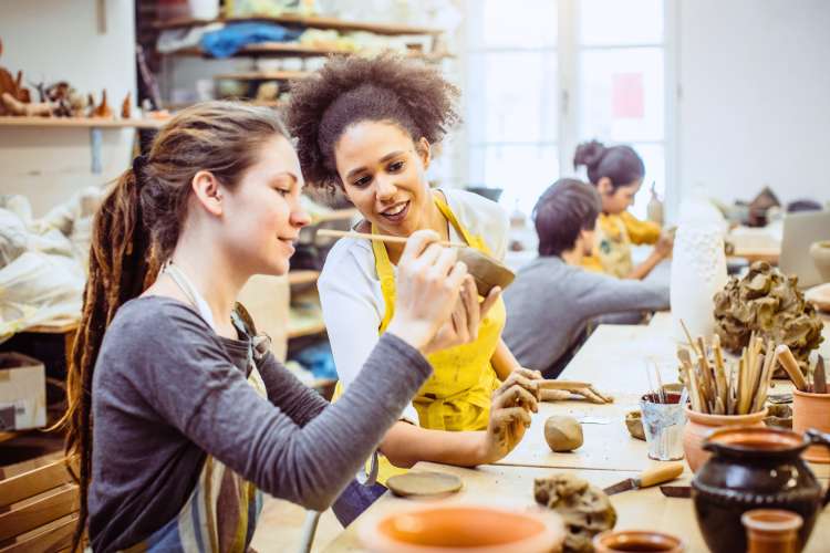 people smiling in pottery classes in Minneapolis