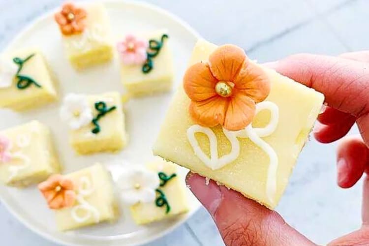 Close-up of a person's fingers holding a petit four from 17 Berkshire