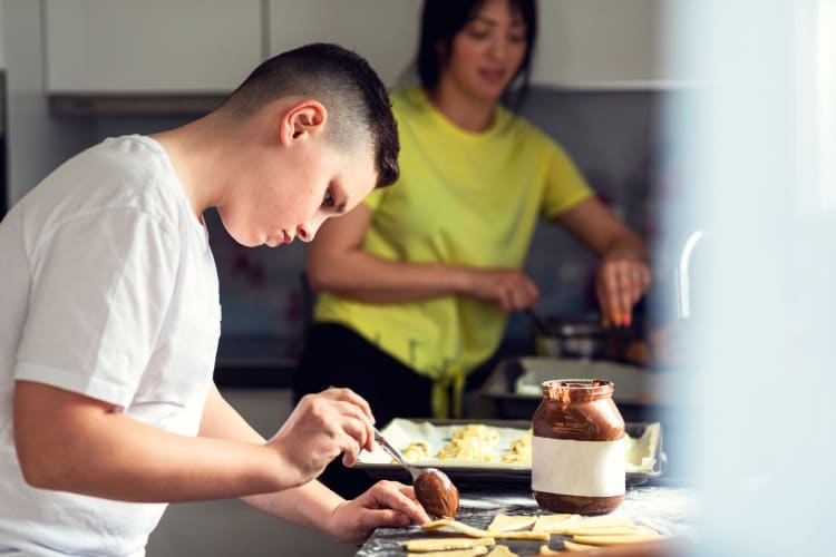 A teenager cooking as part of a 17th birthday idea.