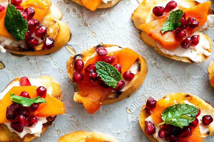 pomegranate persimmon crostini are colorful, bite sized vegan christmas appetizers