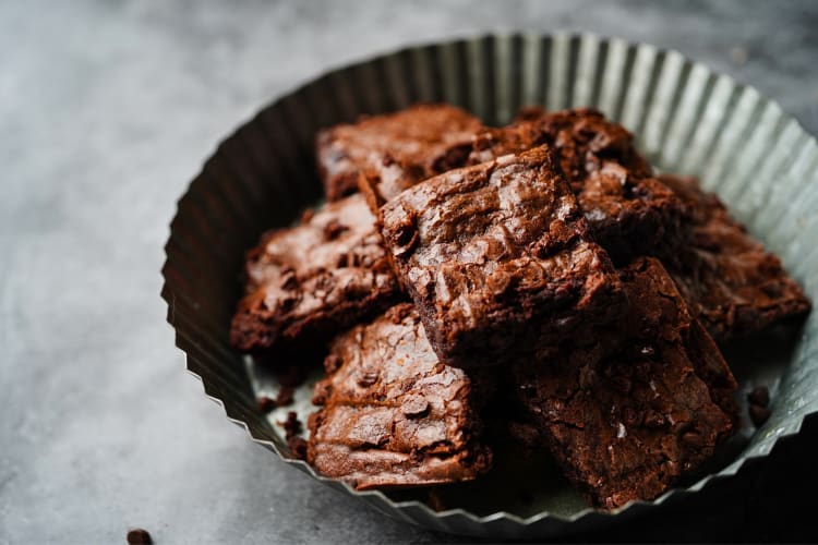 Brownies with flaky crust in a bowl made from the best brownie mix